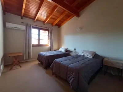 a bedroom with two beds and a window at Casa Lucerna in Cordoba