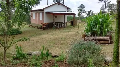 a small house in the middle of a field at Espejo de Hadas - Terrafirme in Villa Yacanto
