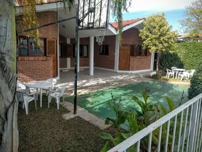 a house with a pool in the yard at Cabañas Bosque in Villa Carlos Paz