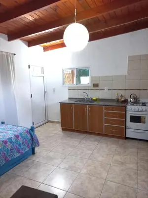 a large kitchen with a sink and a stove at Árbol de Oro - Terrafirme in Villa Yacanto