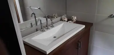 a bathroom sink with two faucets on top of it at La Mexicana - Alta Gracia in Alta Gracia
