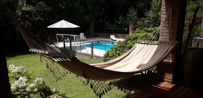 a hammock in a yard next to a pool at La Mexicana - Alta Gracia in Alta Gracia
