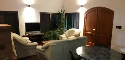 a living room with two chairs and a tv at La Mexicana - Alta Gracia in Alta Gracia