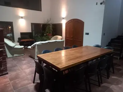 a living room with a wooden table and chairs at La Mexicana - Alta Gracia in Alta Gracia
