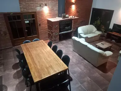 a living room with a table and a couch and chairs at La Mexicana - Alta Gracia in Alta Gracia