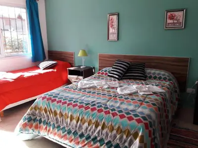 a bedroom with a large bed and a red bed sidx sidx sidx sidx at APART DEUFELL in Embalse