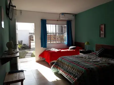 a bedroom with a bed and a window at APART DEUFELL in Embalse