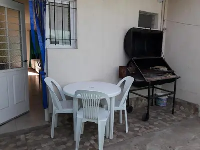 a table and chairs and a piano in a room at APART DEUFELL in Embalse