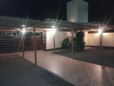a night time view of a house with lights at APART DEUFELL in Embalse