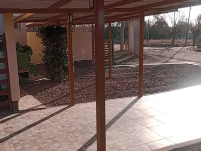 an empty patio with a wooden pergola at APART DEUFELL in Embalse