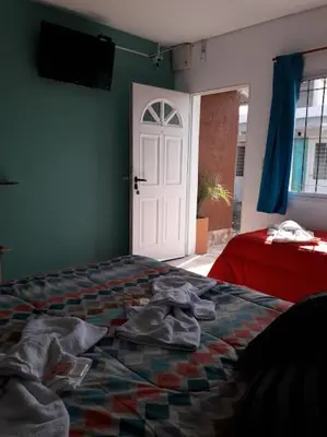 a bedroom with a bed and a white door at APART DEUFELL in Embalse