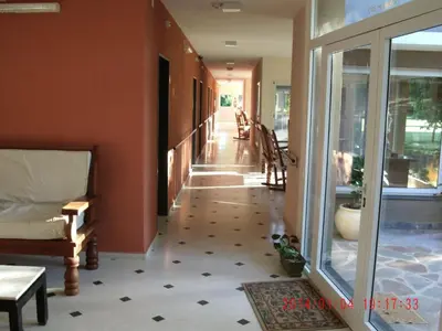 a hallway of a house with glass doors and a floor at Hotel de Campo Posada la Esperanza in Río Cuarto