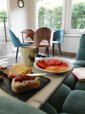 a table topped with a plate of fruit and bread at Atelier Hotel de Charme in Villa General Belgrano