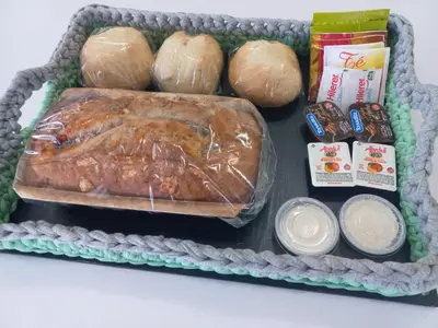 a lunch box with a loaf of bread and other foods at Alto de Balcon B in Tanti