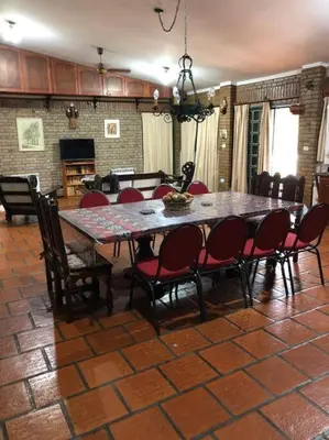 a dining room with a table and chairs at CASA CON VISTA A LAS SIERRAS in Villa Carlos Paz
