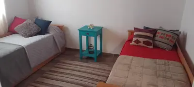 a room with two beds and a blue night stand at Complejo Serena in Santa Rosa de Calamuchita