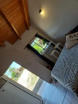 an overhead view of a bedroom with a bed and a window at Complejo Serena in Santa Rosa de Calamuchita