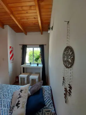 a bedroom with a bed and a clock on the wall at Complejo Serena in Santa Rosa de Calamuchita