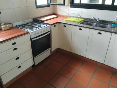 a kitchen with a stove and a sink at HolaViajerosVGB in Villa General Belgrano