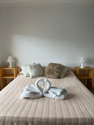 two swans towels are sitting on a bed at Cba Rent in Cordoba