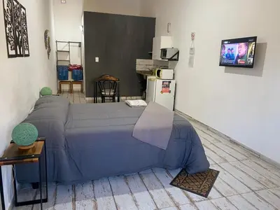 a bedroom with a blue bed in a room at Complejo LA MERLINA in Merlo