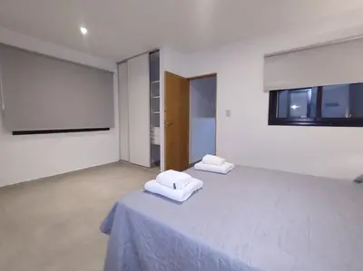 two white towels sitting on a bed in a room at Complejo Claret, Departamentos a metros de Sanatorio Allende y Hospital Privado Cerro in Cordoba