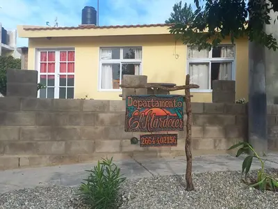 a sign in front of a house at El Atardecer in Cortaderas