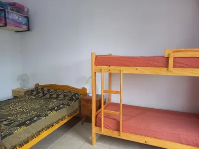 a bedroom with two bunk beds and a bed at El Atardecer in Cortaderas