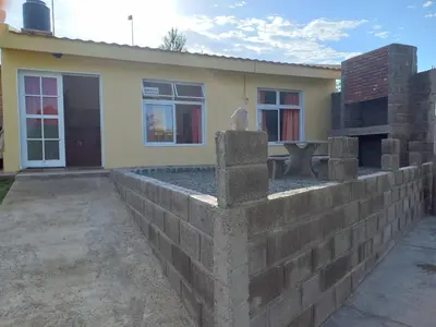 a retaining wall in front of a house at El Atardecer in Cortaderas