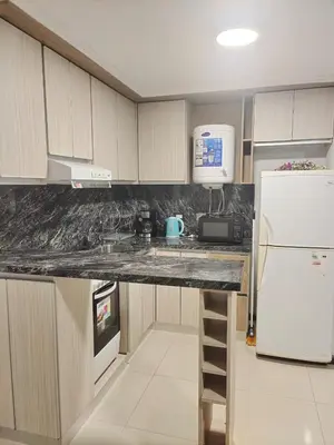 a kitchen with a counter and a white refrigerator at Apartamento Carlos Paz in Villa Carlos Paz