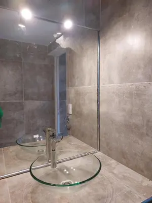a bathroom with a sink and a glass shower at Altos del Monte in Villa Rumipal