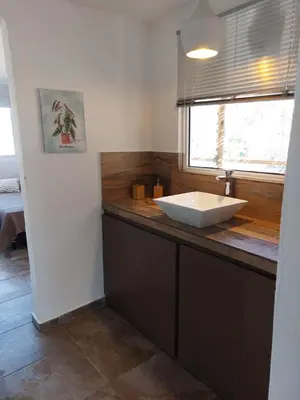 a bathroom with a sink and a window at Altos del Monte in Villa Rumipal