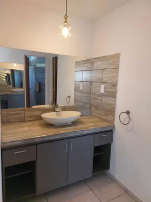 a bathroom with a sink and a mirror at Altos del Monte in Villa Rumipal