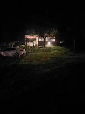 a car parked in front of a house at night at Altos del Monte in Villa Rumipal