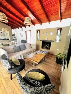 a living room with a couch and a table at Casa Las Magnolias Villa General Belgrano in Villa General Belgrano