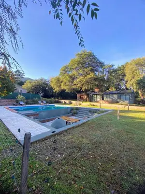a swimming pool in the backyard of a house at Casa Las Magnolias Villa General Belgrano in Villa General Belgrano