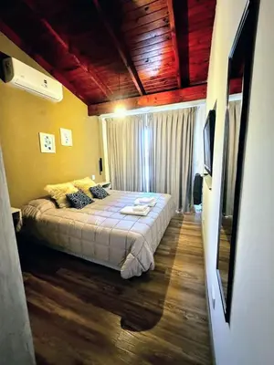 a bedroom with a large bed in a room at Casa Las Magnolias Villa General Belgrano in Villa General Belgrano
