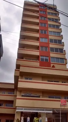 a tall building with red and brown windows at Torre del Lago VI in Villa Carlos Paz