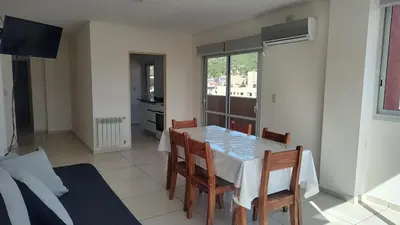 a kitchen and dining room with a table and chairs at Torre del Lago VI in Villa Carlos Paz