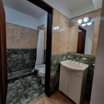 a bathroom with a sink and a toilet and a shower at Posada Yumei in Villa General Belgrano