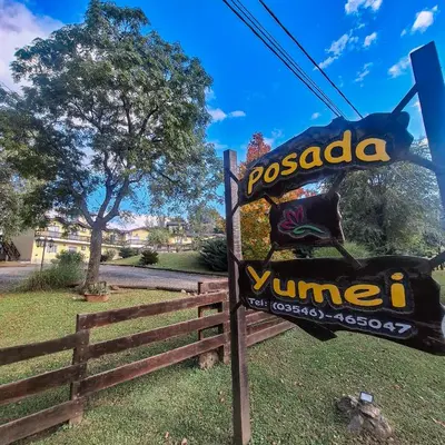 a sign that says pascola village next to a fence at Posada Yumei in Villa General Belgrano