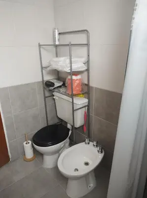 a small bathroom with a toilet and a sink at Makipura in Cordoba