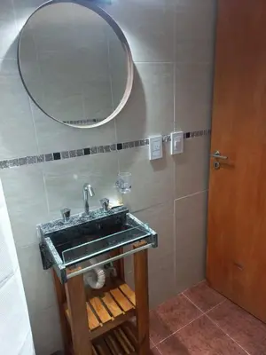 a bathroom with a sink and a mirror at Chalets de la paix in Santa Rosa de Calamuchita