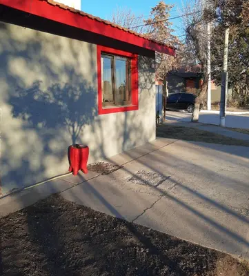 a red fire hydrant sitting on the side of a building at Doña Vanina in Villa Larca