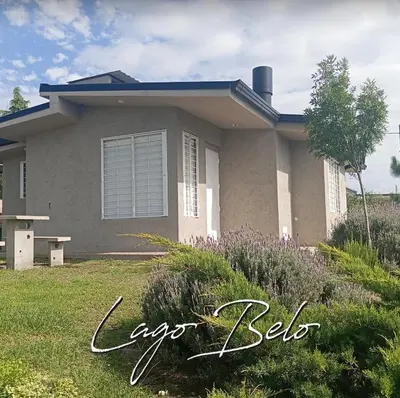 a house with a lawn in front of it at Lago Belo in Cordoba