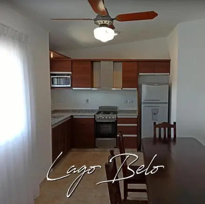 a kitchen with a table and a ceiling fan at Lago Belo in Cordoba