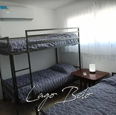 a bedroom with two bunk beds and a table at Lago Belo in Cordoba