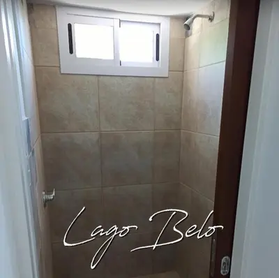 a bathroom with a shower with a window at Lago Belo in Cordoba