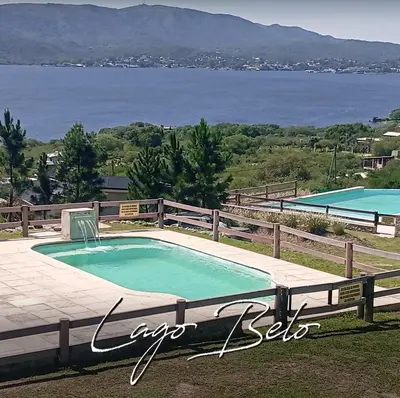 a swimming pool with a view of the water at Lago Belo in Cordoba