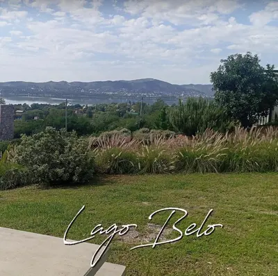 a sign that says crop leeds sitting on a grass field at Lago Belo in Cordoba